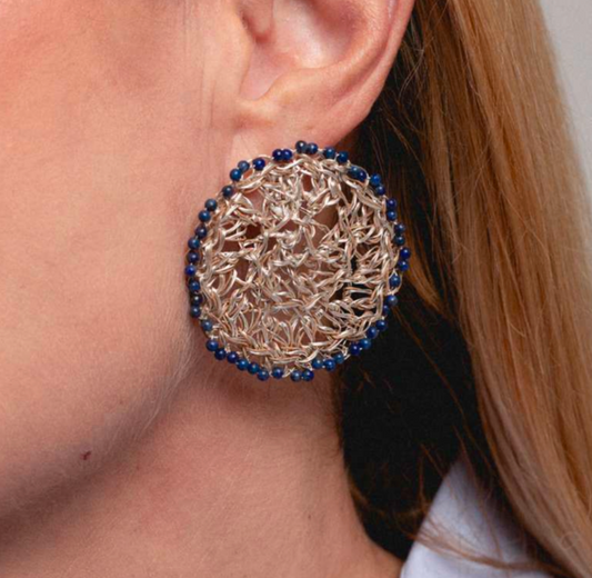 Hara Karamichali | The Sunstone is surrounded by circles of blue lapis.